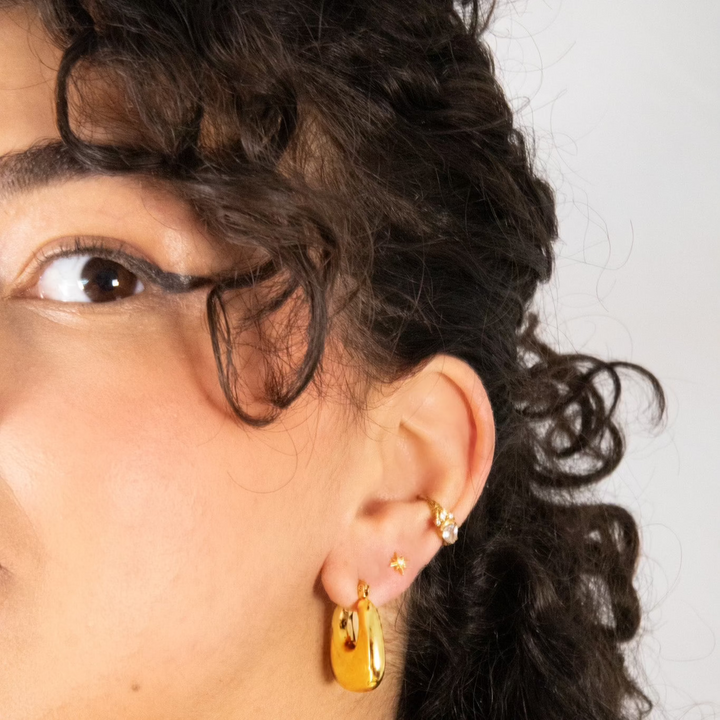 A pair of delicate yet bold hoop earrings with a smooth finish, vintage but modern. Made from recycled gold.