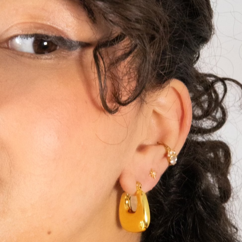 A pair of delicate yet bold hoop earrings with a smooth finish, vintage but modern. Made from recycled gold.