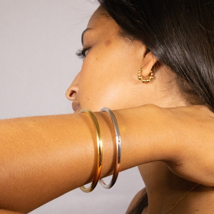 A gold bangle or a silver bangle with a hinge to fit every wrist. Sustainable. Anti tarnish. The perfect gift.