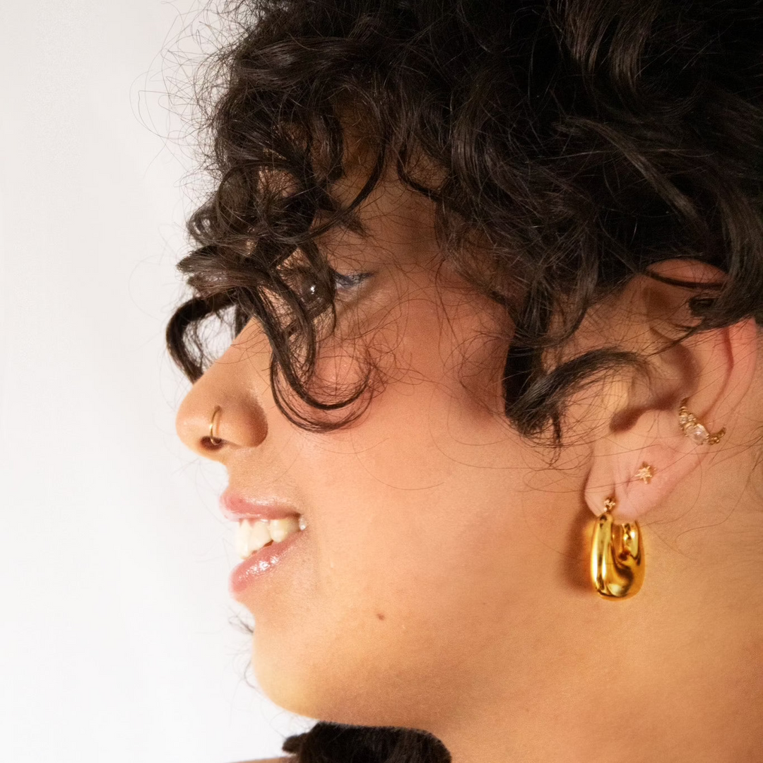 A pair of delicate yet bold hoop earrings with a smooth finish, vintage but modern. Made from recycled gold.