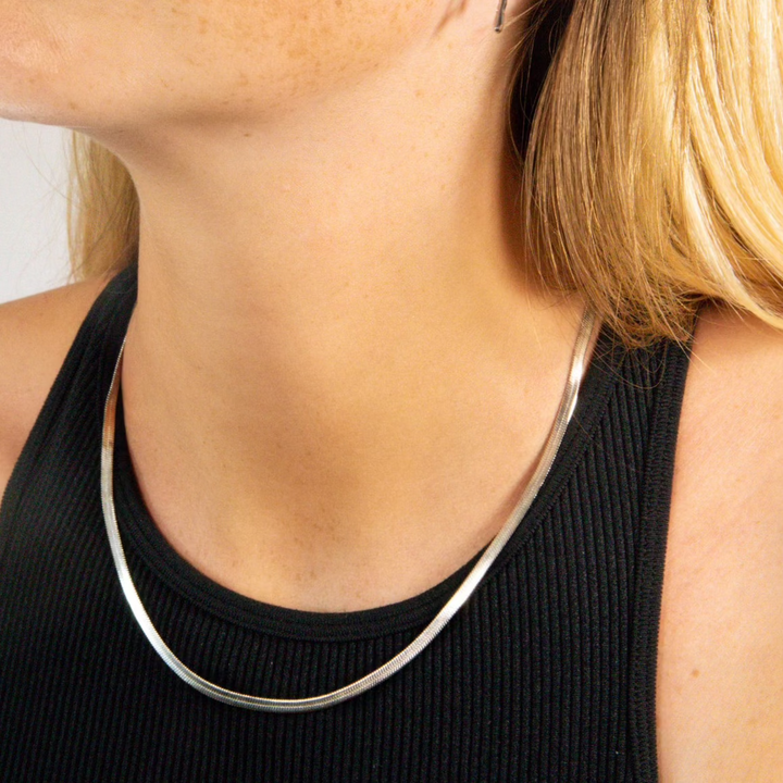 A herringbone chain necklace. Available in recycled gold or silver. Water & sweat proof to wear everyday, even to the gym.